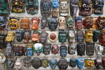 Poster masks on wall in nepal © paul prescott