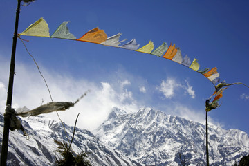 praying flags floating in the wind in  the annapurna, nepal