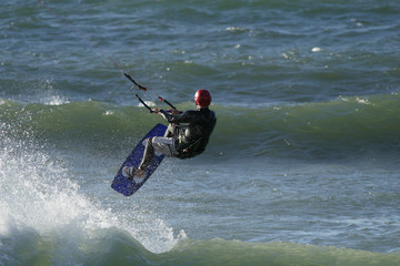 A kitesurfer riding the waves in the ocean