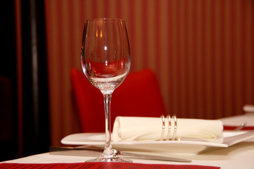 Red room with empty glass and white napkins