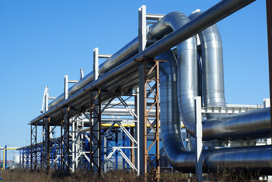industrial pipelines on pipe-bridge against blue sky