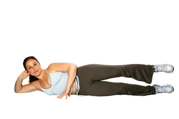  sports woman laying on her side, doing leg raises,
