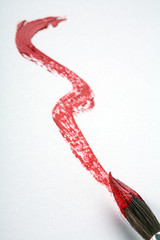 Obraz na płótnie Canvas single red stroke with paintbrush