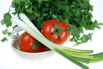 Close up to fresh onion, tomato and parsley