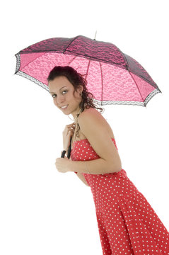 Woman with pink umbrella in black dress on white background.