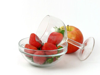 Strawberry in a glass bowl and apple