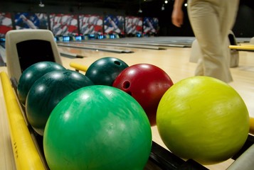 Fototapeta na wymiar Bowling balls in the rack at a bowling alley.