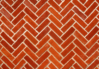 Abstract close up of a zigzag pattern red brick wall.