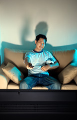 Obraz premium Man watching television at night
