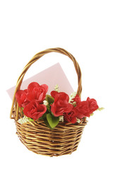 Fototapeta na wymiar Red Roses and Greetings Card in Basket