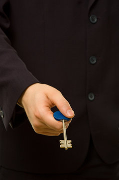 Businessman is giving you a key