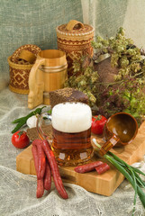 Still life with beer and sausages