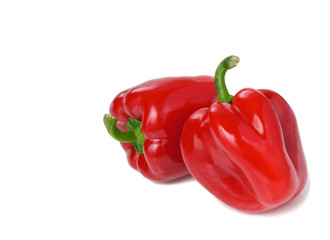Two Red Bell Peppers on White