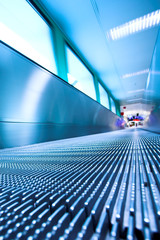 Blue moving escalator in the office hall