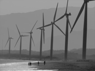 Children playing under the power windmills of Bangui bay