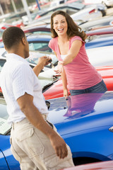 Woman picking up keys to new car © Monkey Business