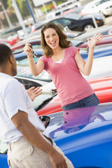 Woman picking up keys to new car © Monkey Business