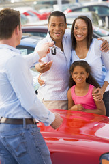 Young family picking up new car © Monkey Business