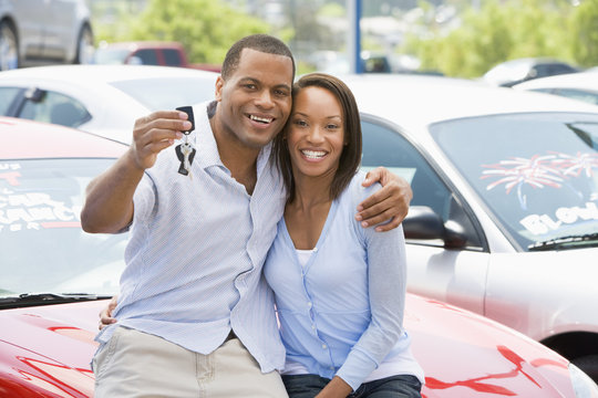 Couple Picking Up New Car