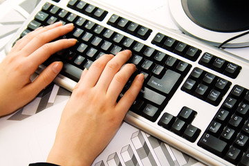 human hands typing on the laptop
