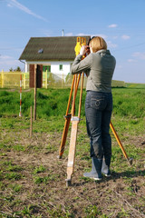 Female geodesist performing geodetic survey