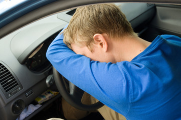 man sleeps in a car
