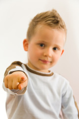 Child showing on somebody by his finger