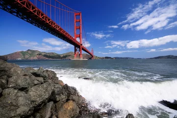 Fotobehang Golden Gate Bridge and surf on the rocks © Stas