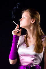 Obraz premium Young elegant woman with cigarette