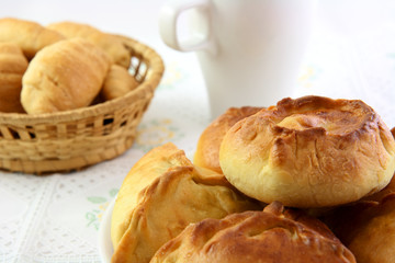 The pie with stuffing, croissant and white cup