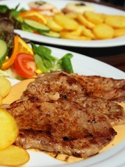 Pig meat with piquant sauce and roast potatoes