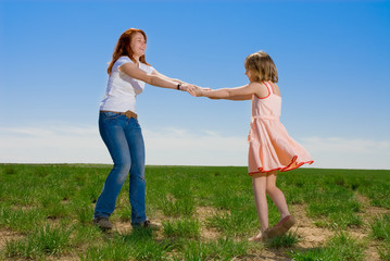 Mother and daughter whirling