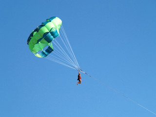 The woman flies on a parachute