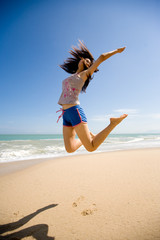 Naklejka premium young woman jumping happily