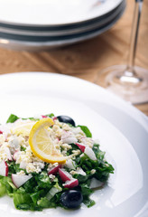 Greek salad with fresh lettuce, radish,feta,olives and lemon