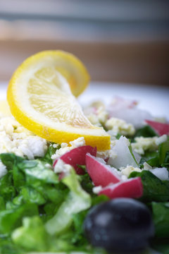 Greek salad with fresh lettuce, radish,feta,olives and lemon