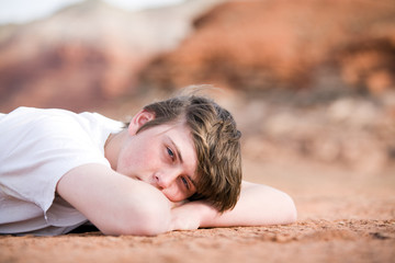 Obraz na płótnie Canvas male teenager laying on ground