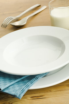 Empty plate with milk glass