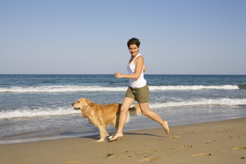Young girl and dog playing