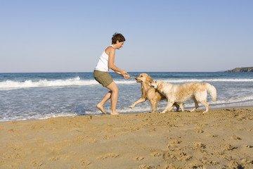 Yong girl playing with her dogs