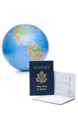 American passports with travel visas in front of world globe