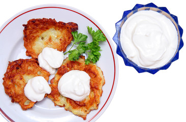 potato pancakes with sour cream isolated on white