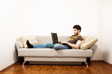 Young man working at home with laptop