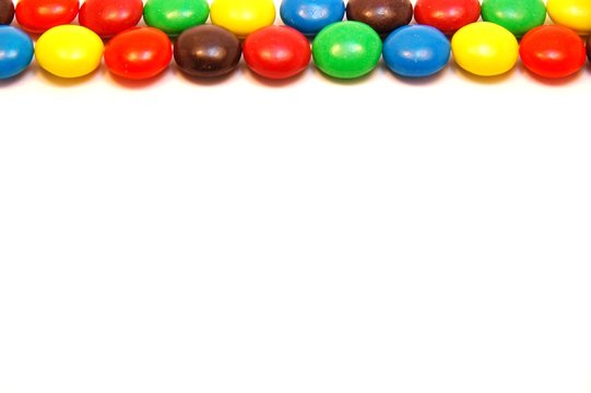 Chocolate candy border on white background