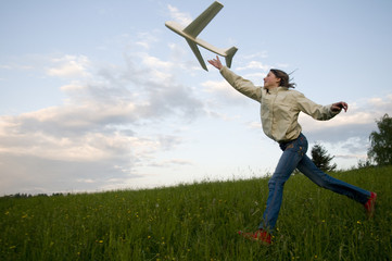 Teenage girl playing on spring meadow