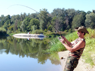 fisherman on the river bank