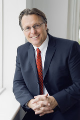 A happy smiling businessman wearing spectacles.