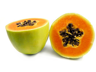 Papaya fruit cut in half isolated on a white background.