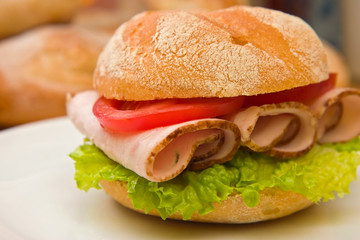 Fresh kaiser bun with turkey breast, lettuce and tomatoes