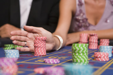 Close up of woman placing bet on roulette table